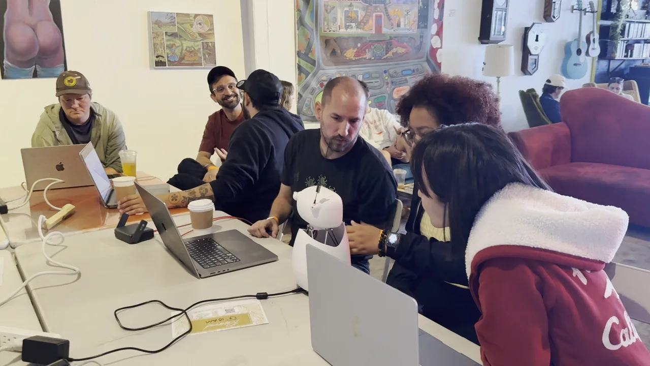 The room at the first Sharathon: builders around one long table in Ocean Beach on May 16, 2026.